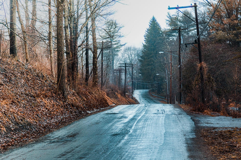 Fog is clearing over a rainy country road in Narrowsburg, NY