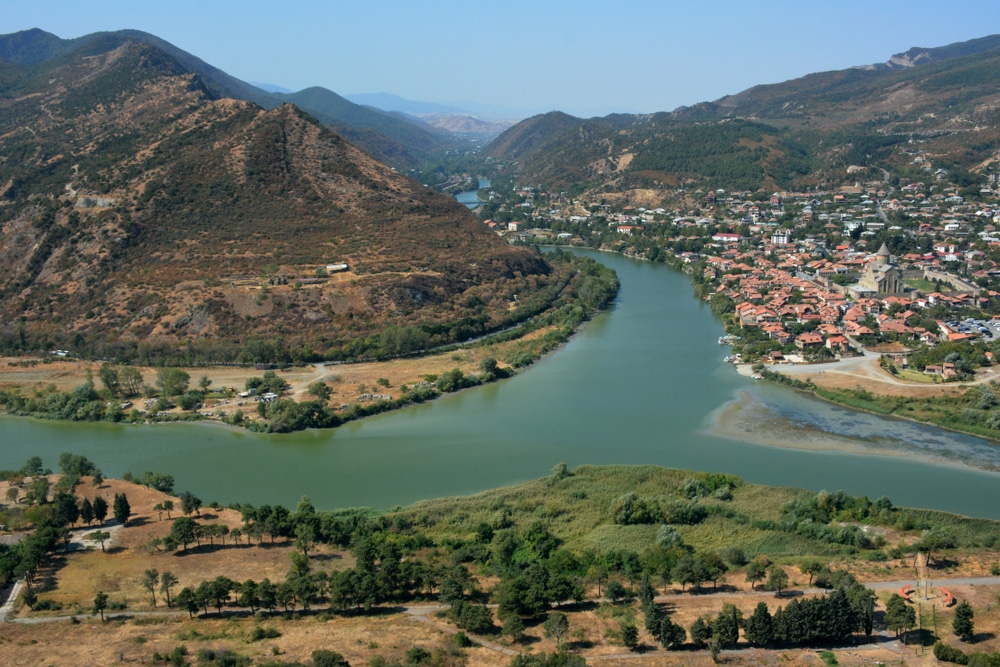 The ancient capital of Georgia Mtskheta on the water of two rivers. Beautiful view of holy city Mtskheta - located on two rivers Mtkvari and Aragvi.