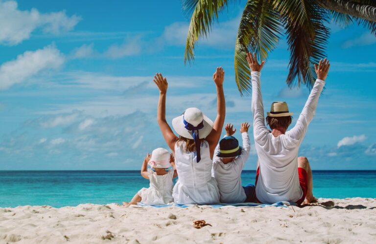 Happy Family with Two Kids Enjoying in A Beach