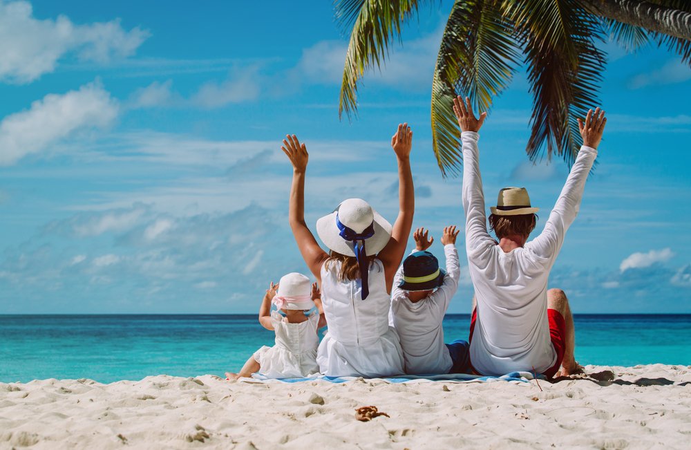 Happy Family with Two Kids Enjoying in A Beach