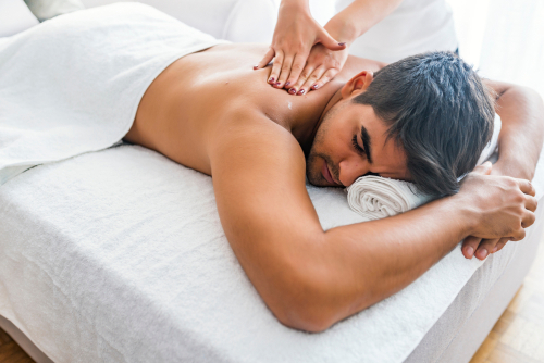 Man having massage in spa salon, closeup. Sports massage.