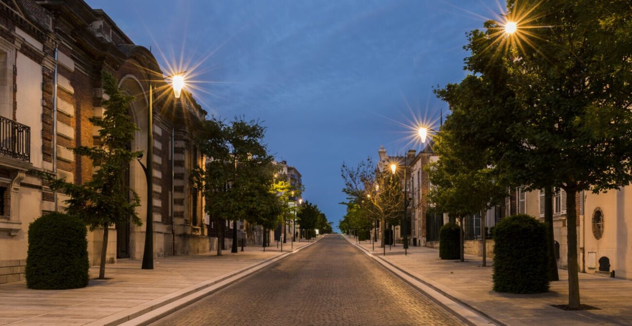 Avenue de Champagne with several Champagne houses along the road with strolling tourists in the evening in Epernay, France.