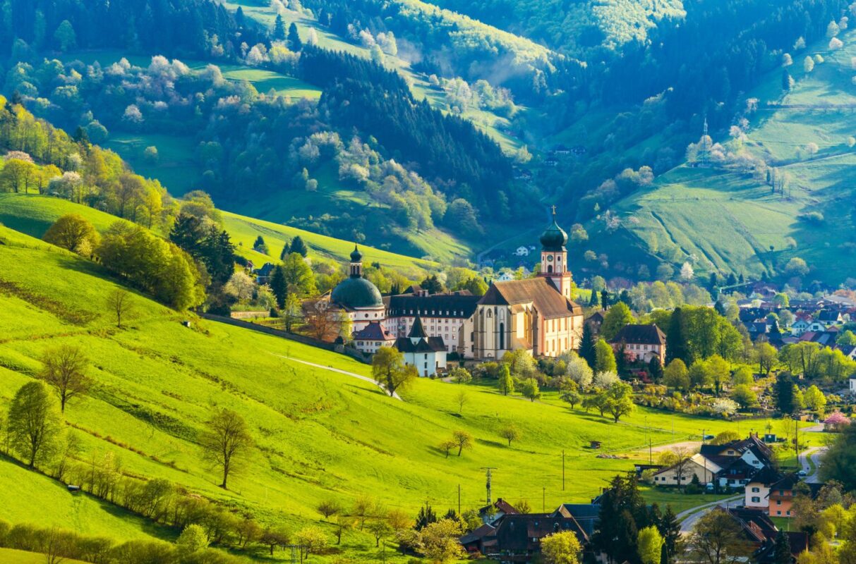 Beautiful countryside mountain landscape with a monastery in village. Germany, Black forest, Muenstertal.