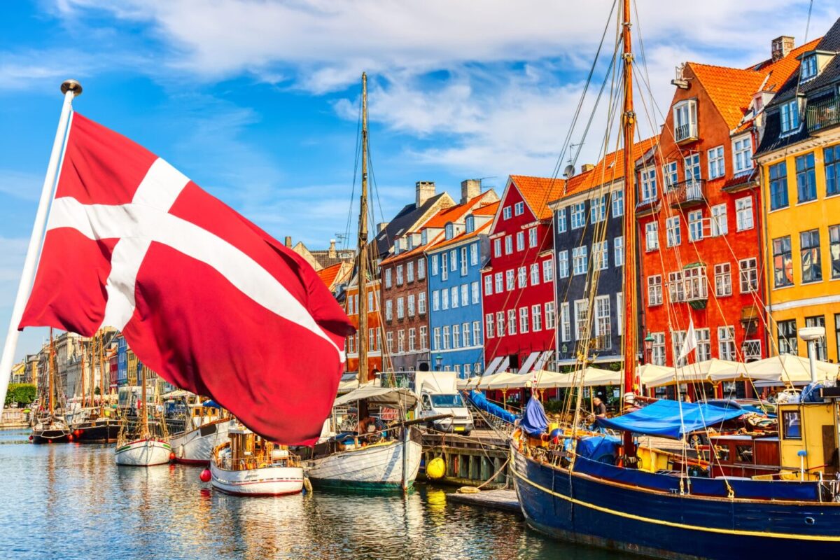 Denmark’s flag flies over Copenhagen harbor.