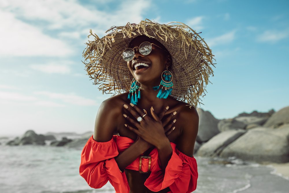 Beautiful African Woman In Red Dress Wearing Straw Hat Smiling