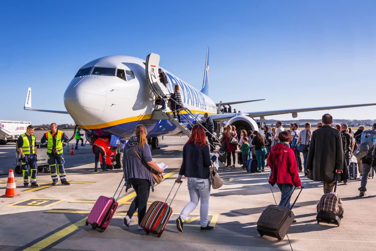 People boarding to Ryanair plane on Lech Walesa Airport in Gdansk. Ryanair operates over 300 aircraft and is the biggest low-cost airline company in Europe.