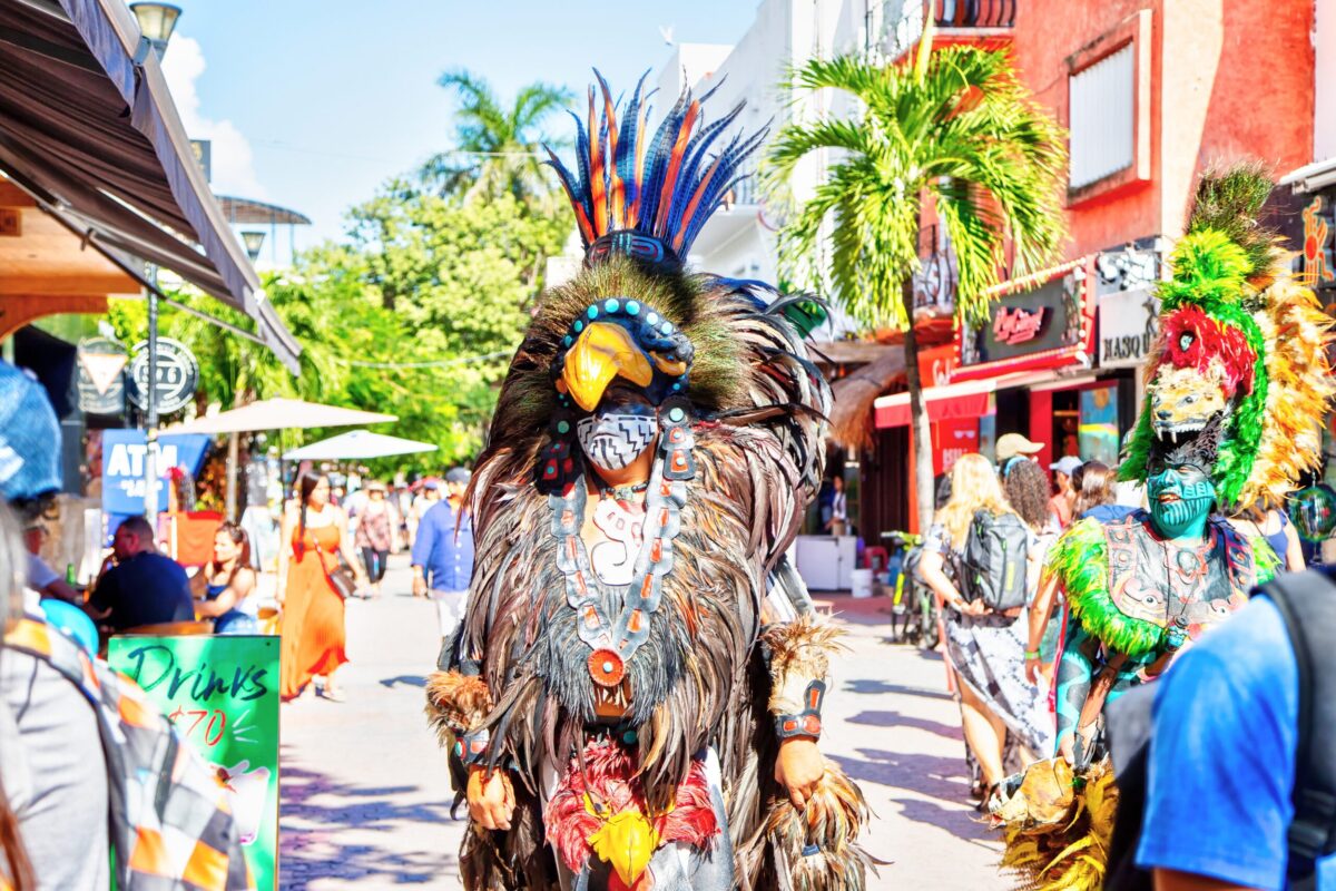 Men dressed in traditional indigenous Mayan warrior costumes perform on famous 5th Avenue in the entertainment district of Playa del Carmen in Riviera Maya.