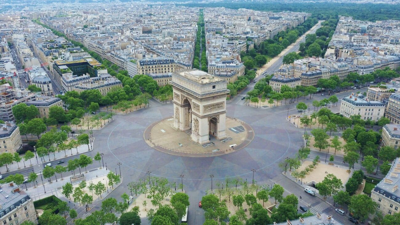 World famous Arc de Triomphe at the city center of Paris, France. Sky view