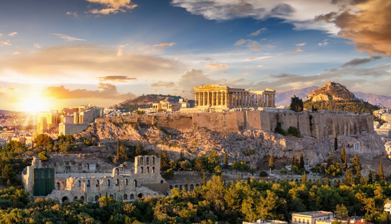 The Acropolis of Athens, Greece, with the Parthenon Temple on top of the hill during a summer sunset. Greece is currently open to American tourists.