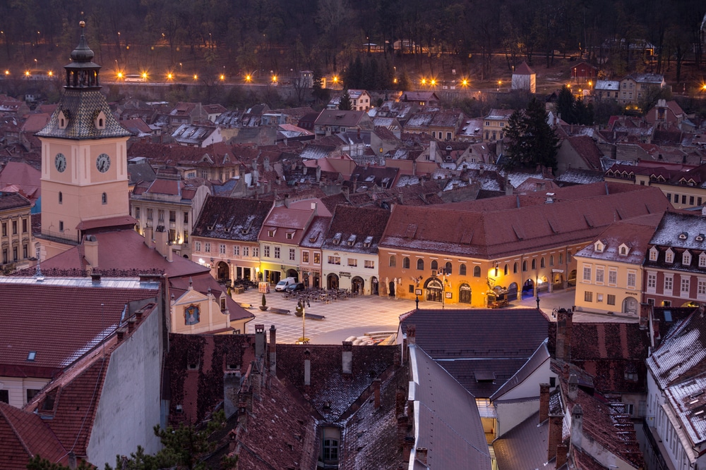 BRASOV, ROMANIA - view of the main square at the Brasov illuminated by the street lamps