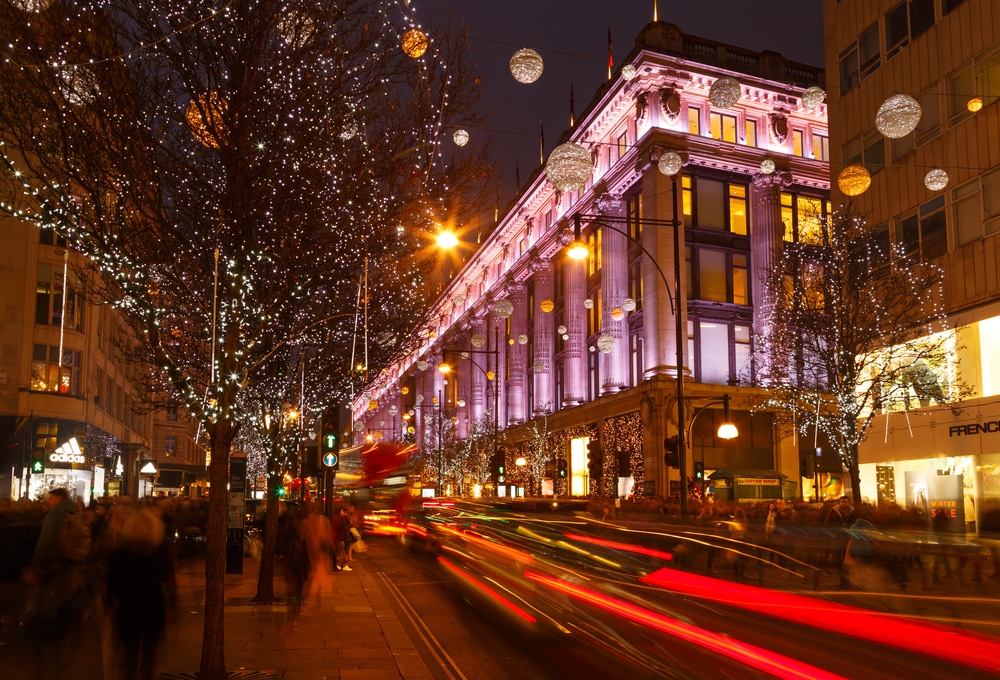 Busy Oxford Street, Christmas shoppers, traffic, and Selfridges. In London, England.