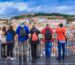 Group of tourists watching the cityscape of Lisbon and taking pictures of the castle architecture in Portugal